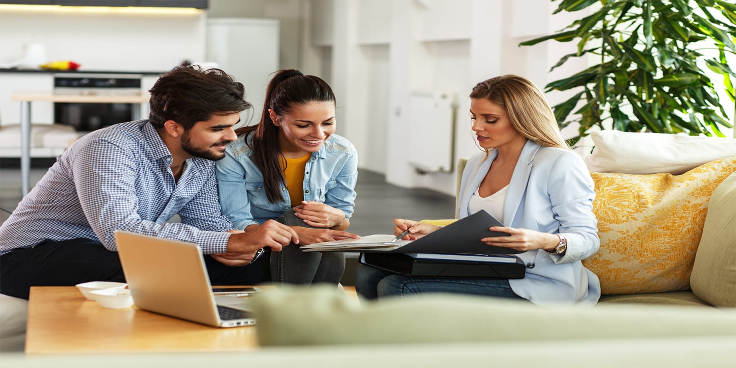Real estate agent consulting with clients